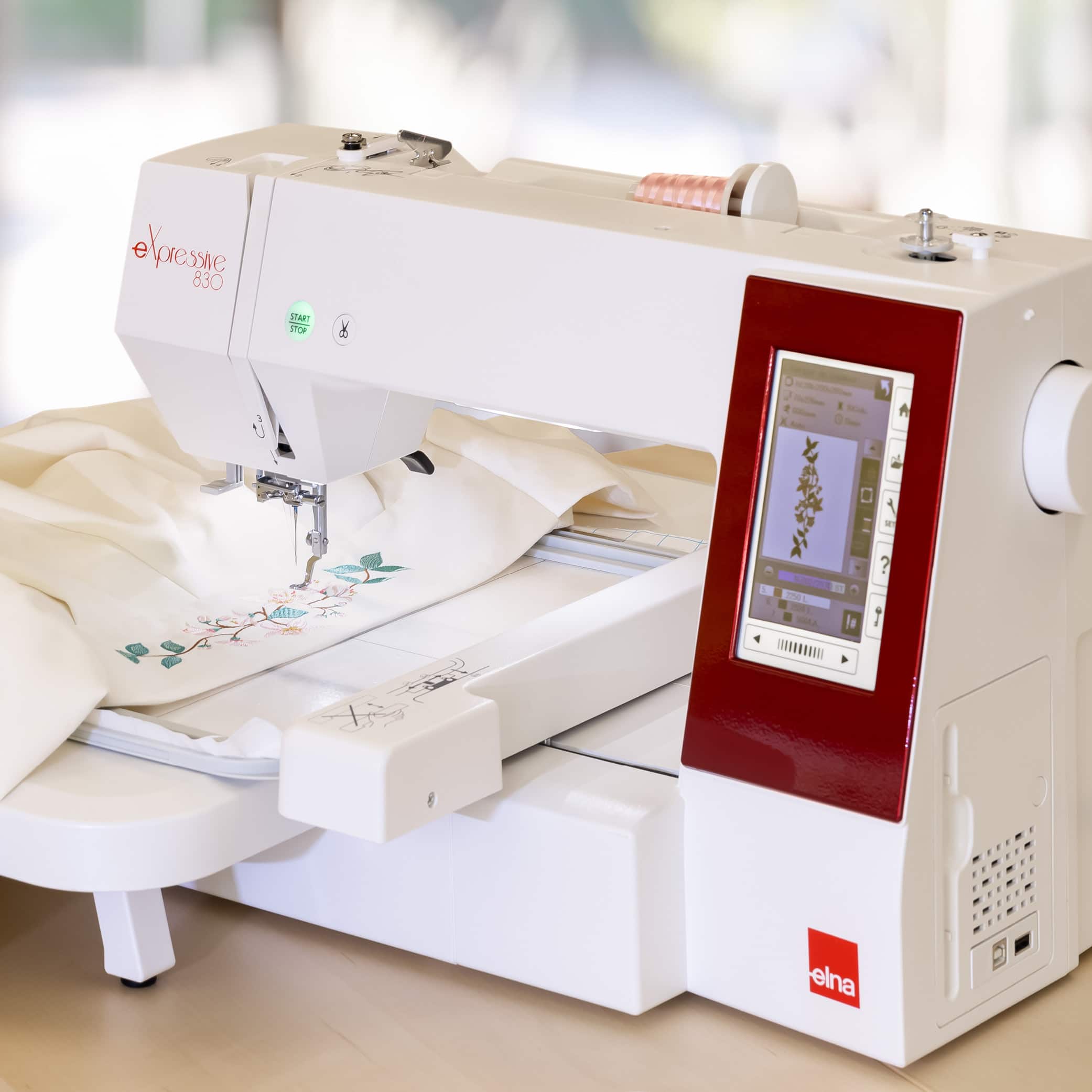 Embroidery machine with floral pattern in progress.