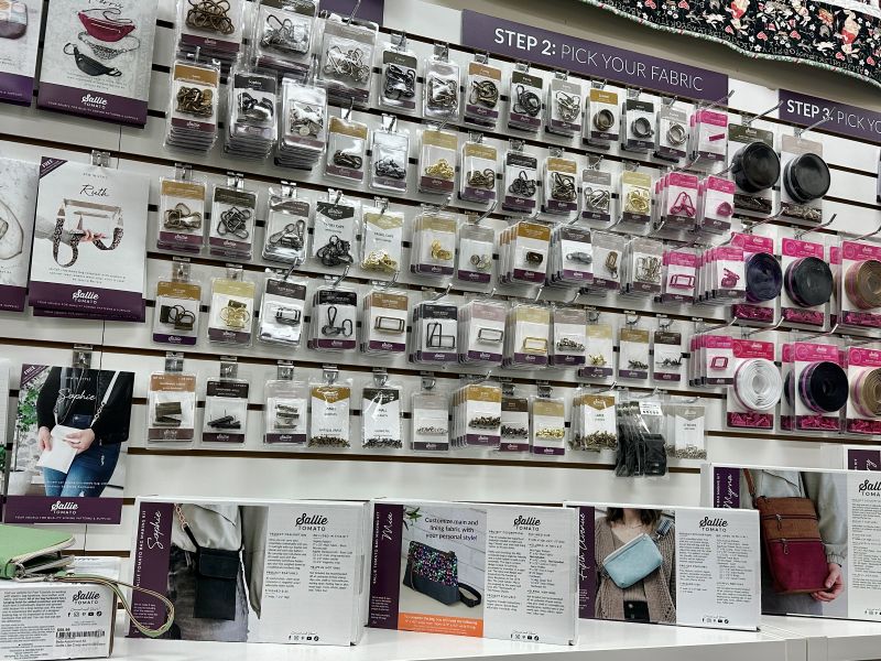 Wall display of sewing accessories in a store. Wall display of sewing accessories in a store.